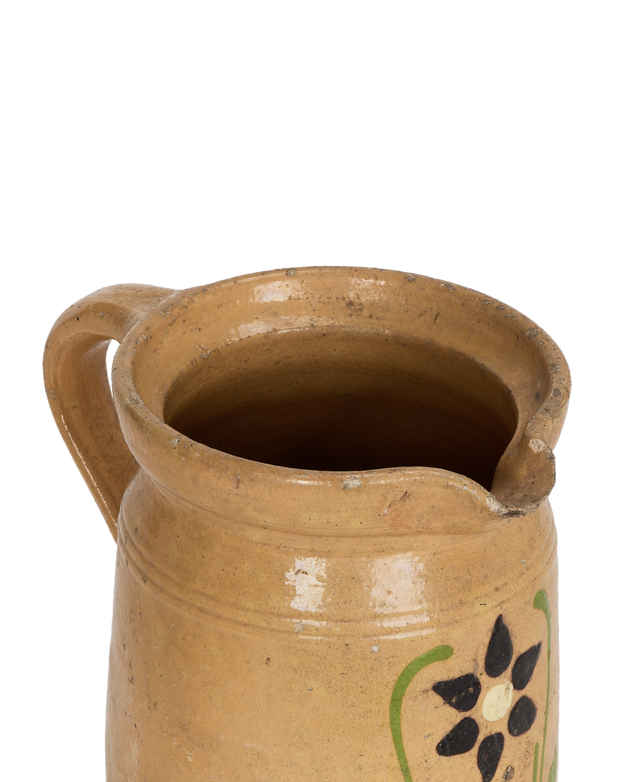 Vintage French mustard yellow Alsatian ceramic pitcher, close-up top view.