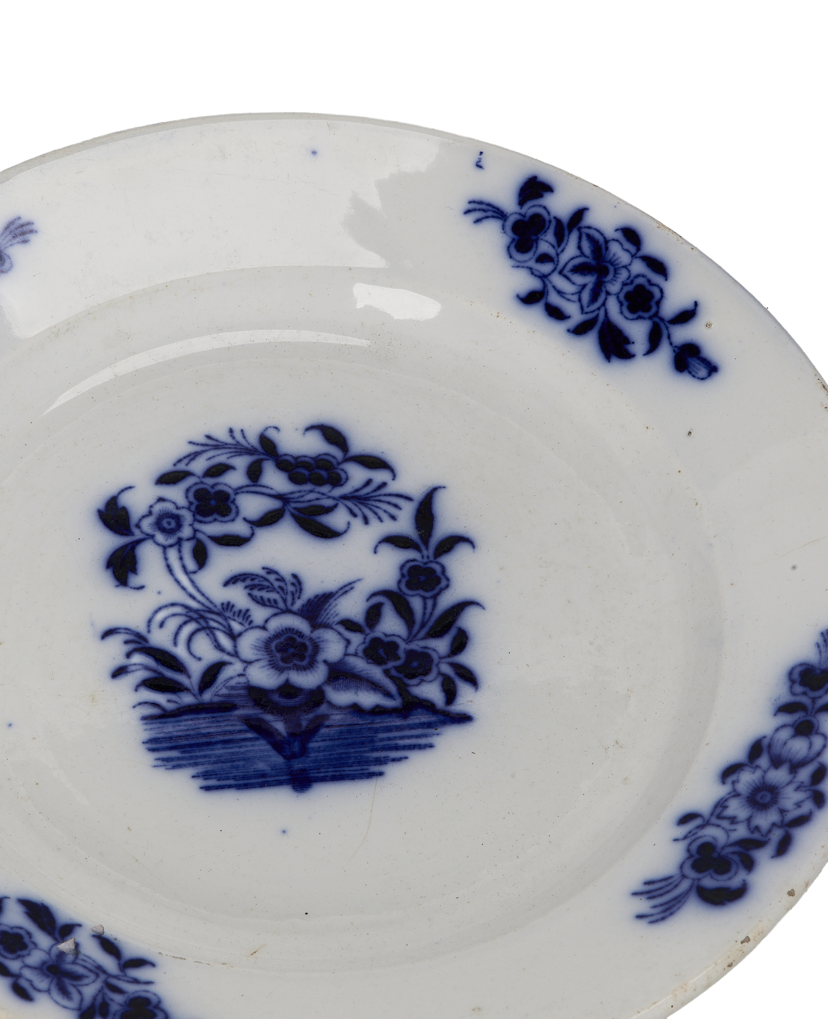Vintage French blue and white plate with detailed floral center, showing condition and design.