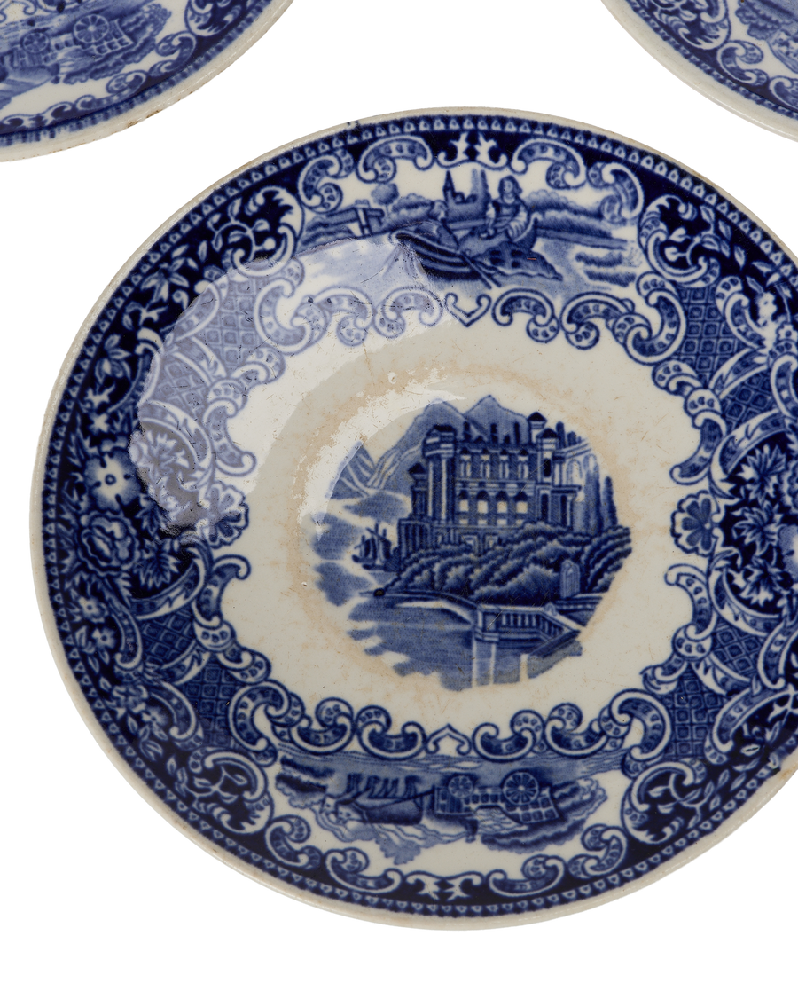 Close-up vintage French bleu porcelain plate showing pattern detail and age.