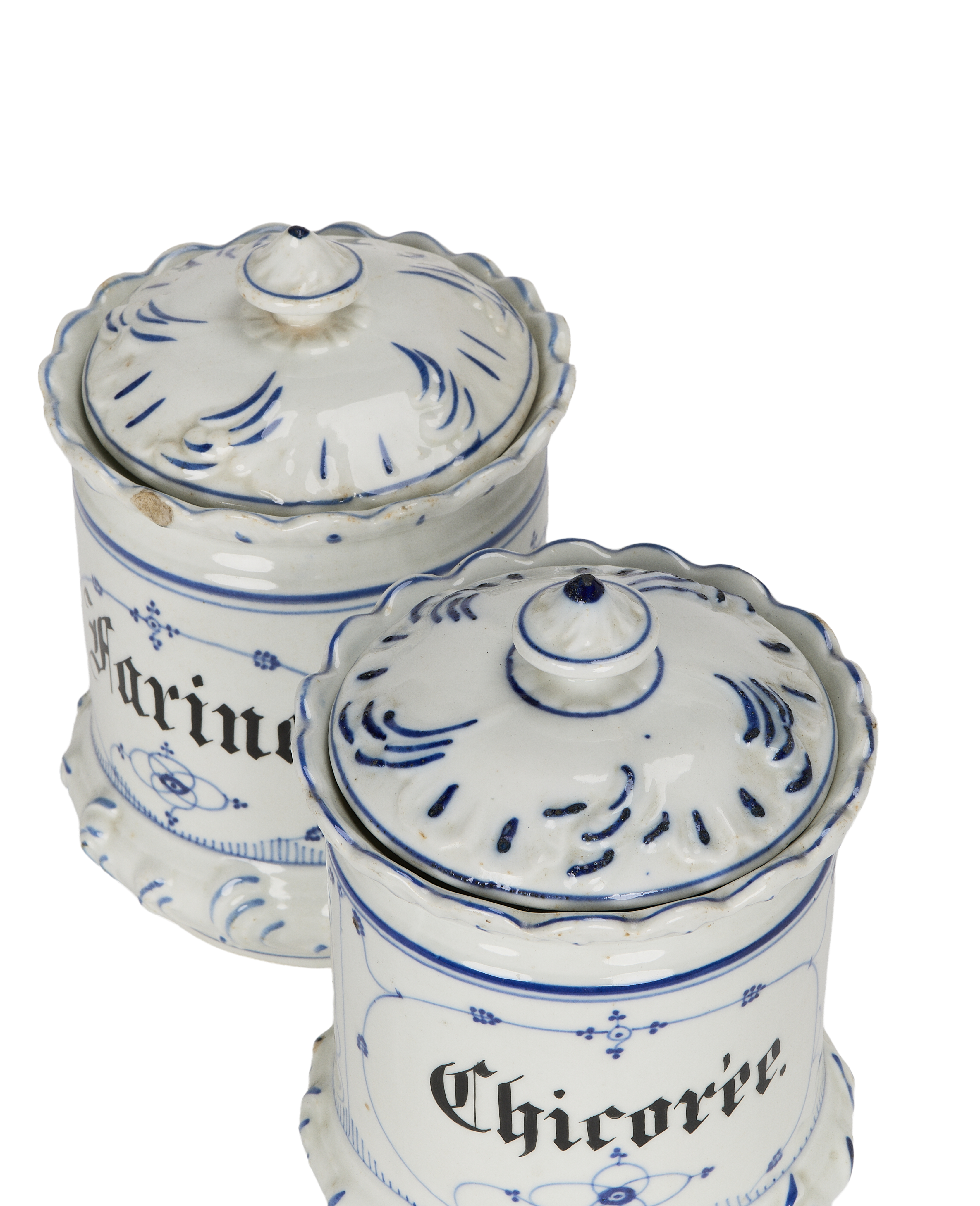Two vintage French blue and white porcelain bulk spice jars with ornate lids.