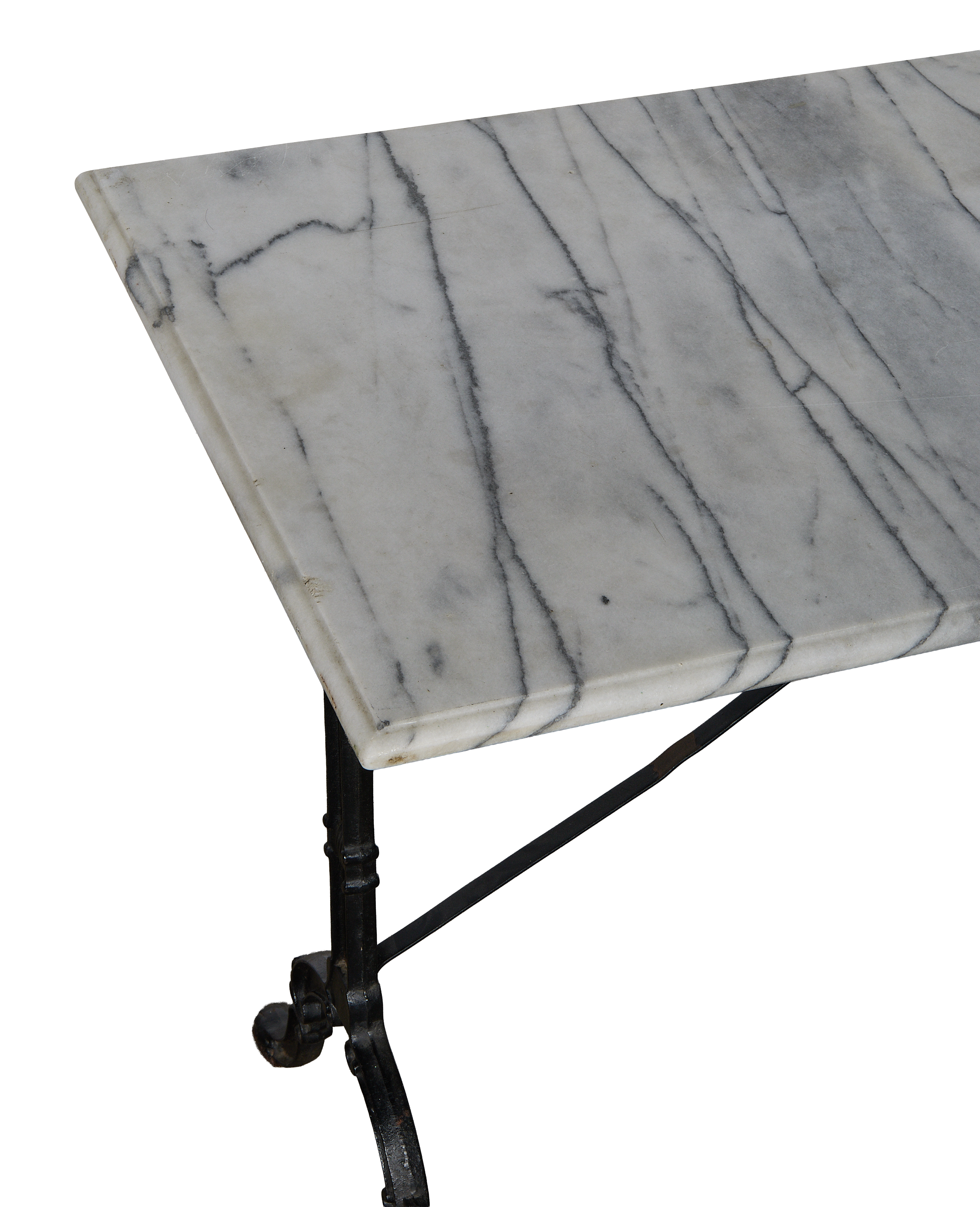 Close-up of vintage French marble bistro table's veined surface and cast iron legs.