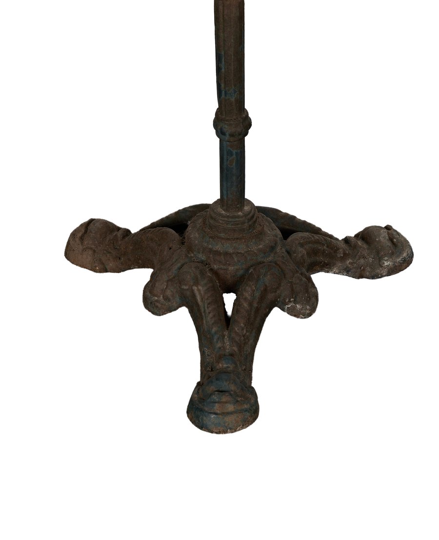 Vintage French cast iron bistro table base with ornate feet, distressed blue-brown patina.