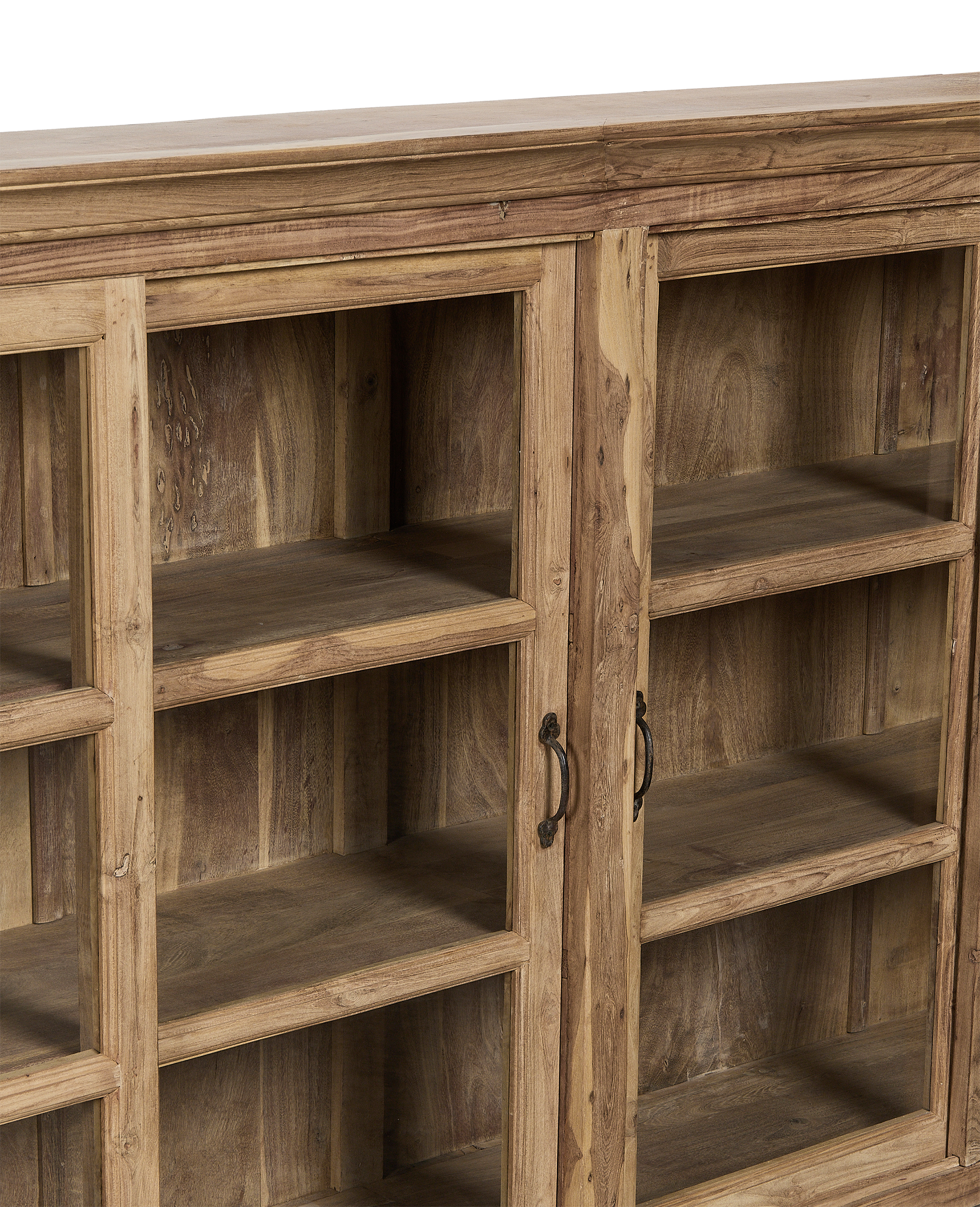 Close-up of vintage bleached oak cabinet from India, showing transparent glazed doors, ornate metal handles, and interior shelving.