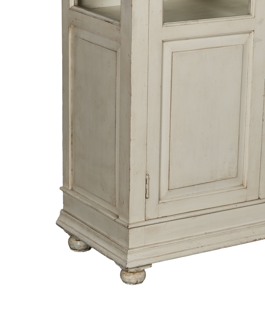 Vintage oak wood cabinet with distressed painted finish, detailed base molding, and round bun feet.