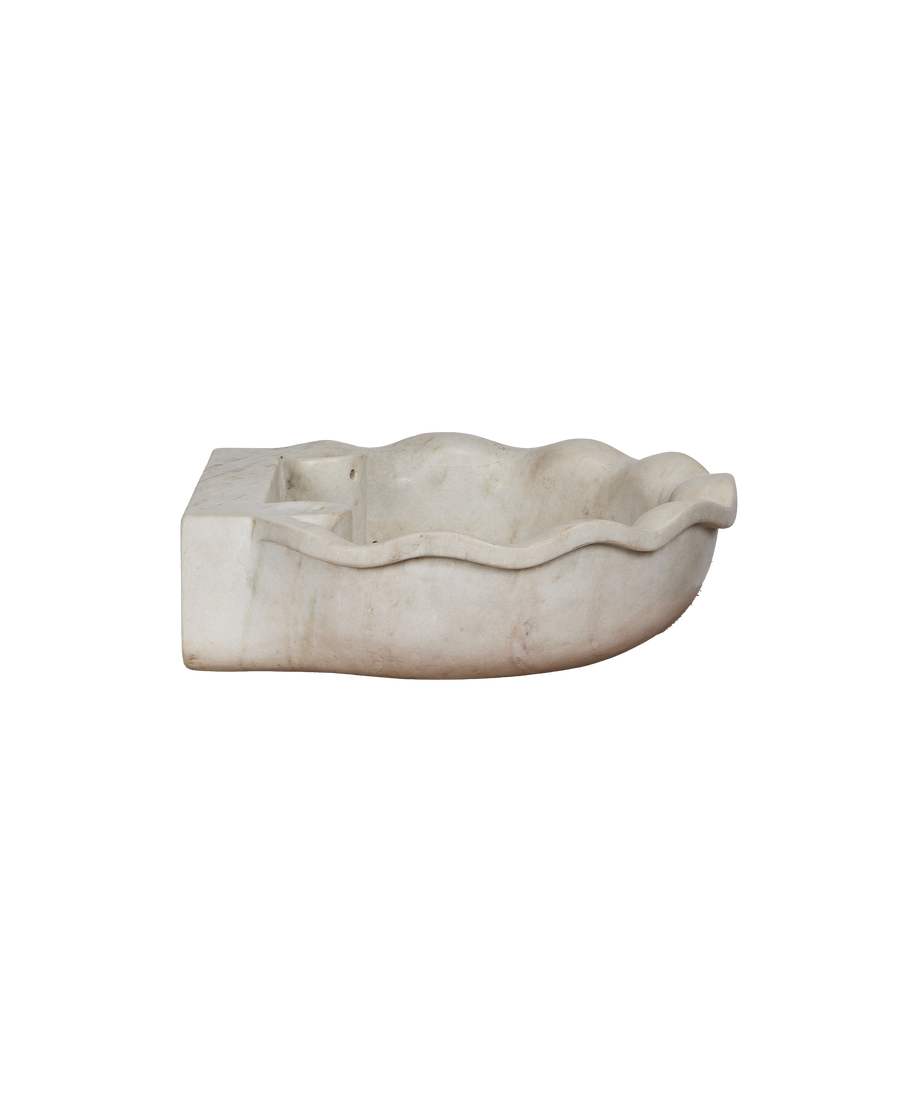 Reproduction Indian marble sink, side view, showing wavy edges and rectangular back.