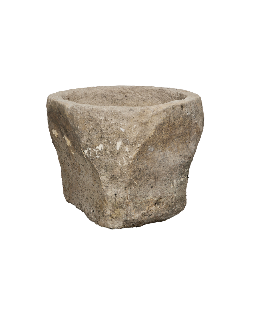 Vintage Indonesian round limestone trough, showing weathered texture and unique organic shape.