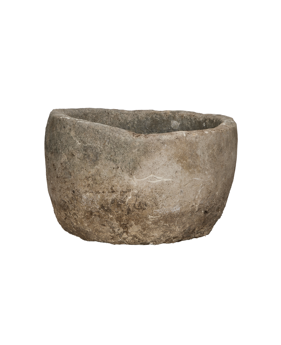 Round vintage Indonesian limestone trough, showing weathered texture from an elevated angle.