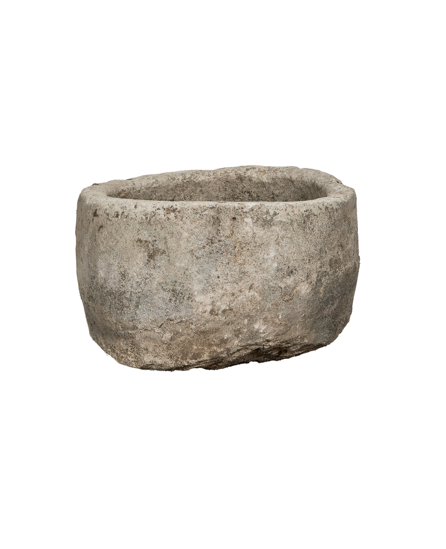 Vintage round limestone trough, aged grey patina, Indonesia, showing textured side and rim.
