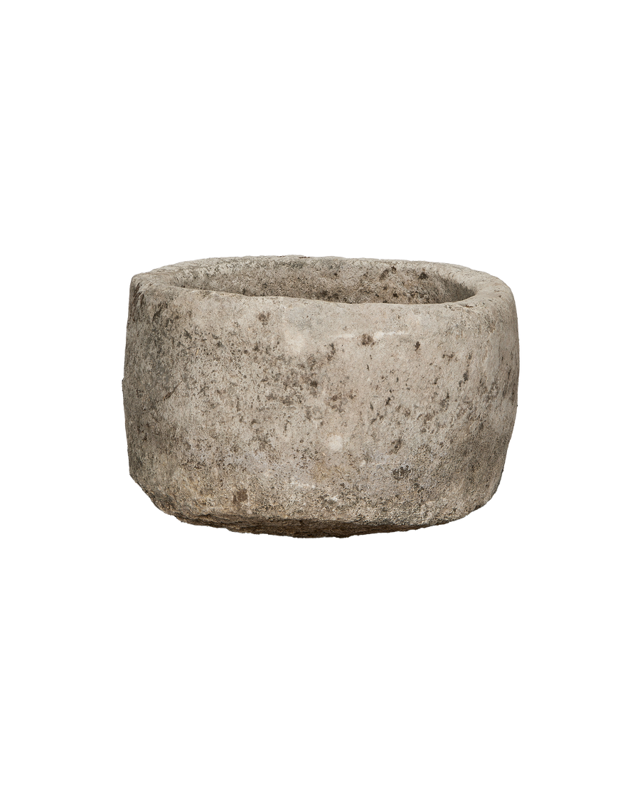Vintage Indonesian round limestone trough, distressed texture, showcasing rough weathered surface.