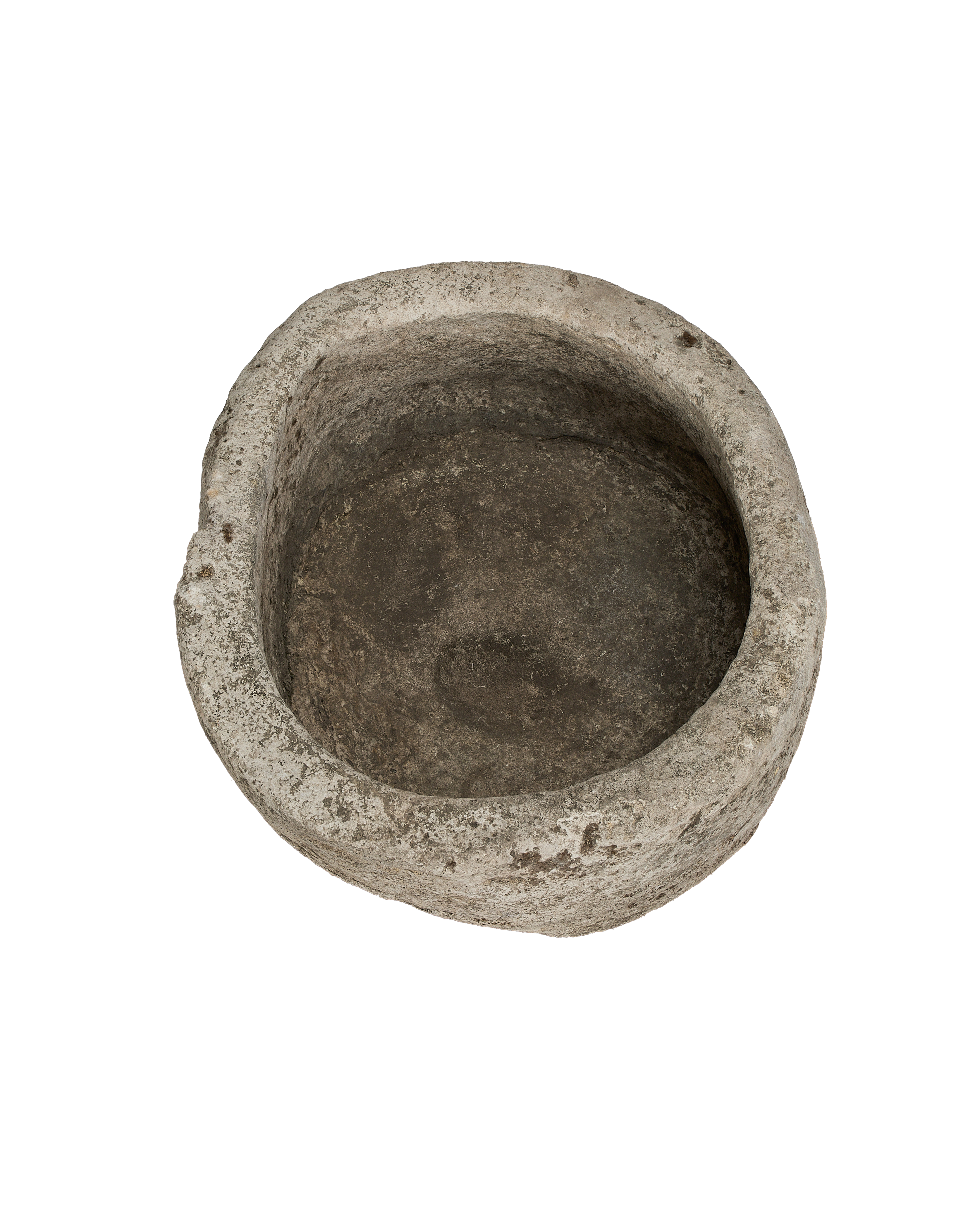 Vintage round Indonesian limestone trough, showing weathered interior basin from top angle.