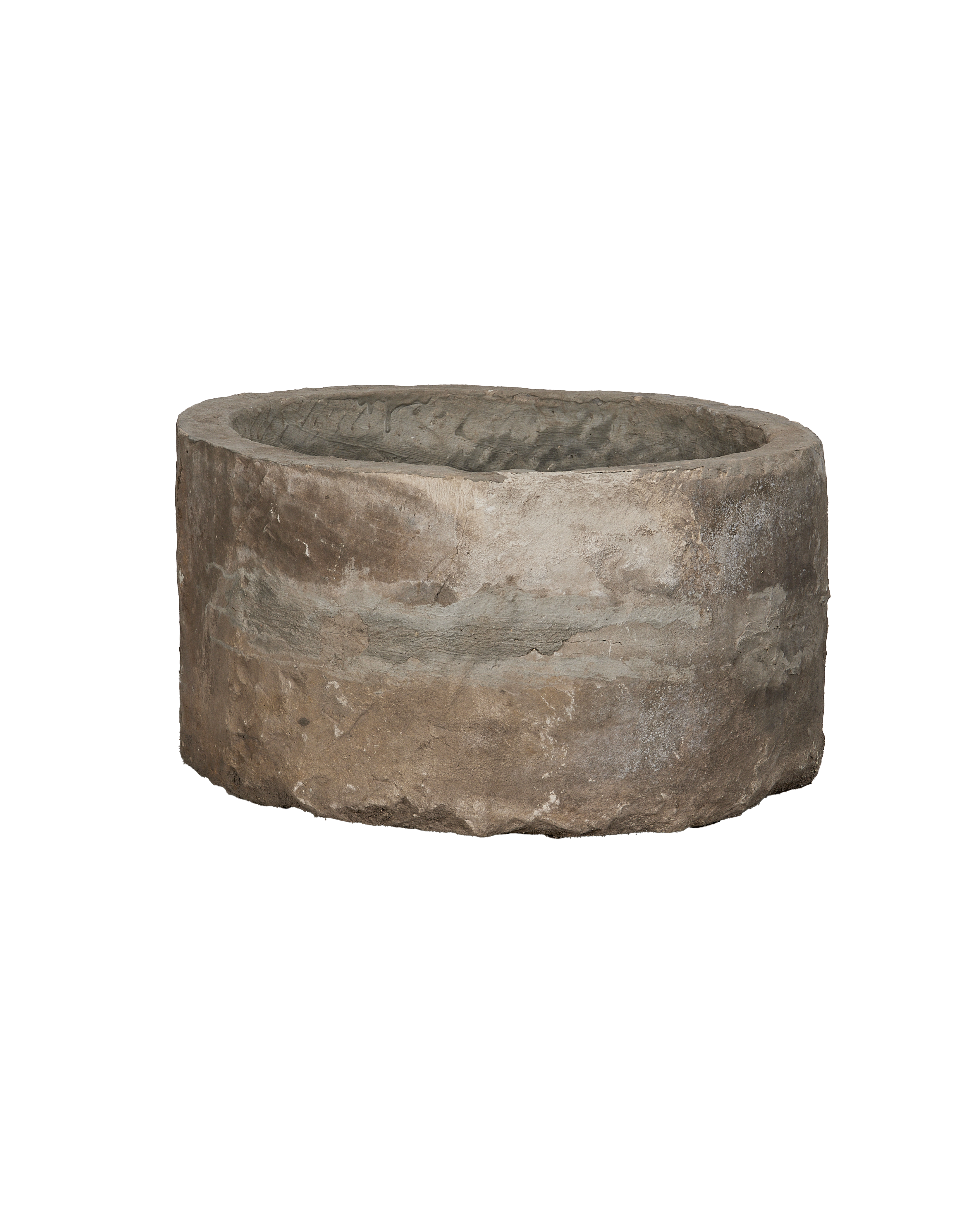 Vintage Indonesian round limestone trough, close-up interior and exterior texture.