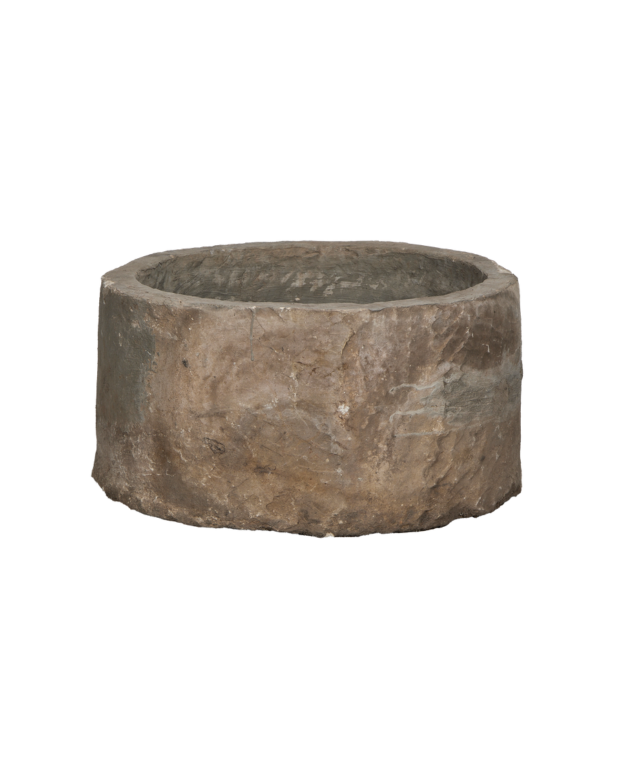 Vintage Indonesian round limestone trough, showing rough weathered exterior texture and condition.