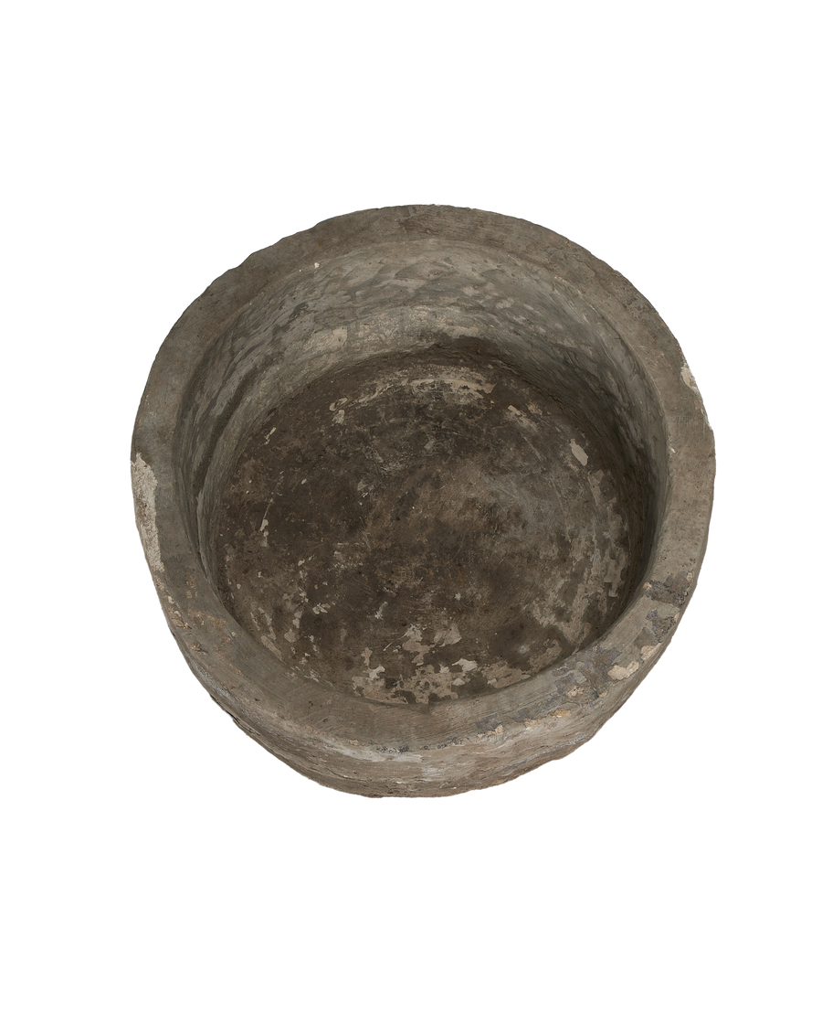 Vintage round limestone trough, full interior view, showing aged patina and unique texture.