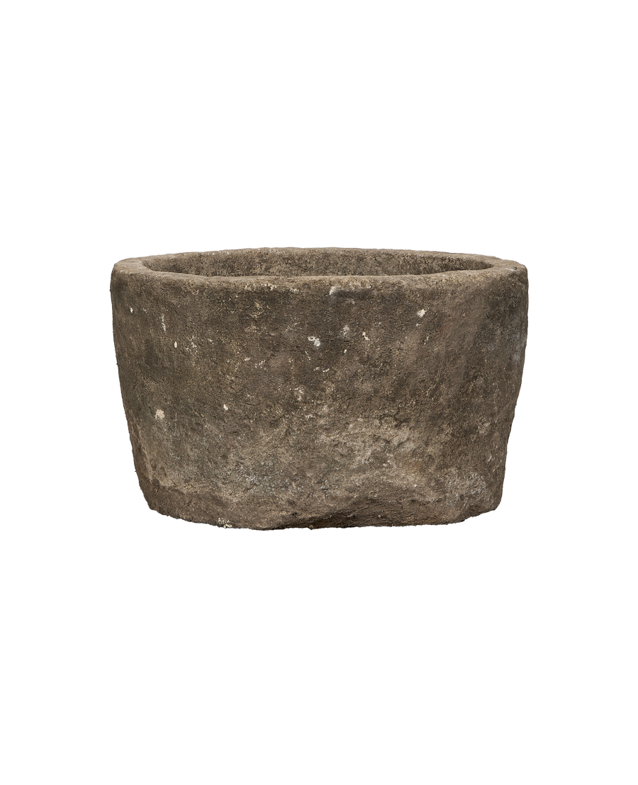 Vintage Indonesian round limestone trough, showing weathered texture and natural imperfections.