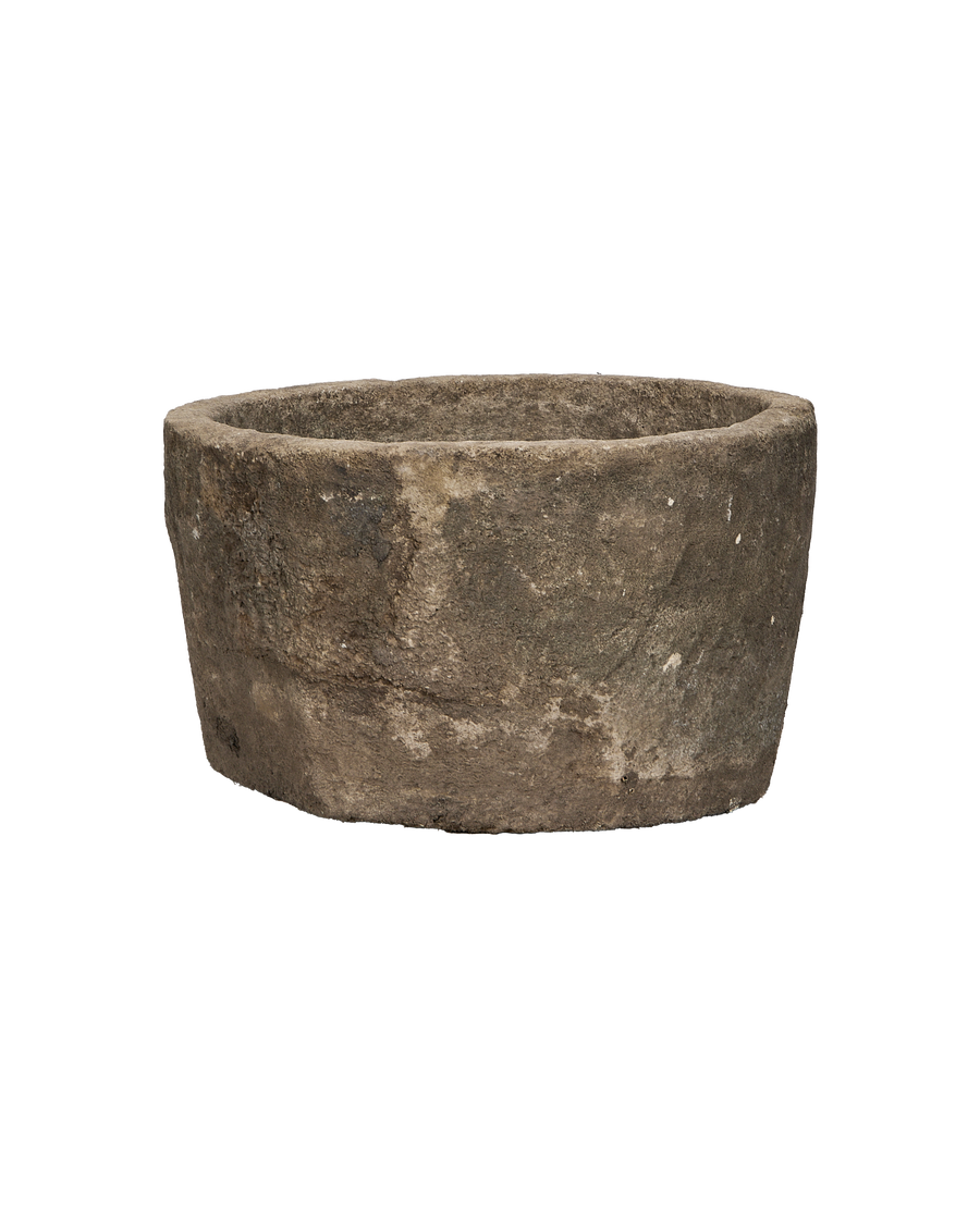 Vintage round limestone trough from Indonesia, showcasing weathered exterior texture and condition.