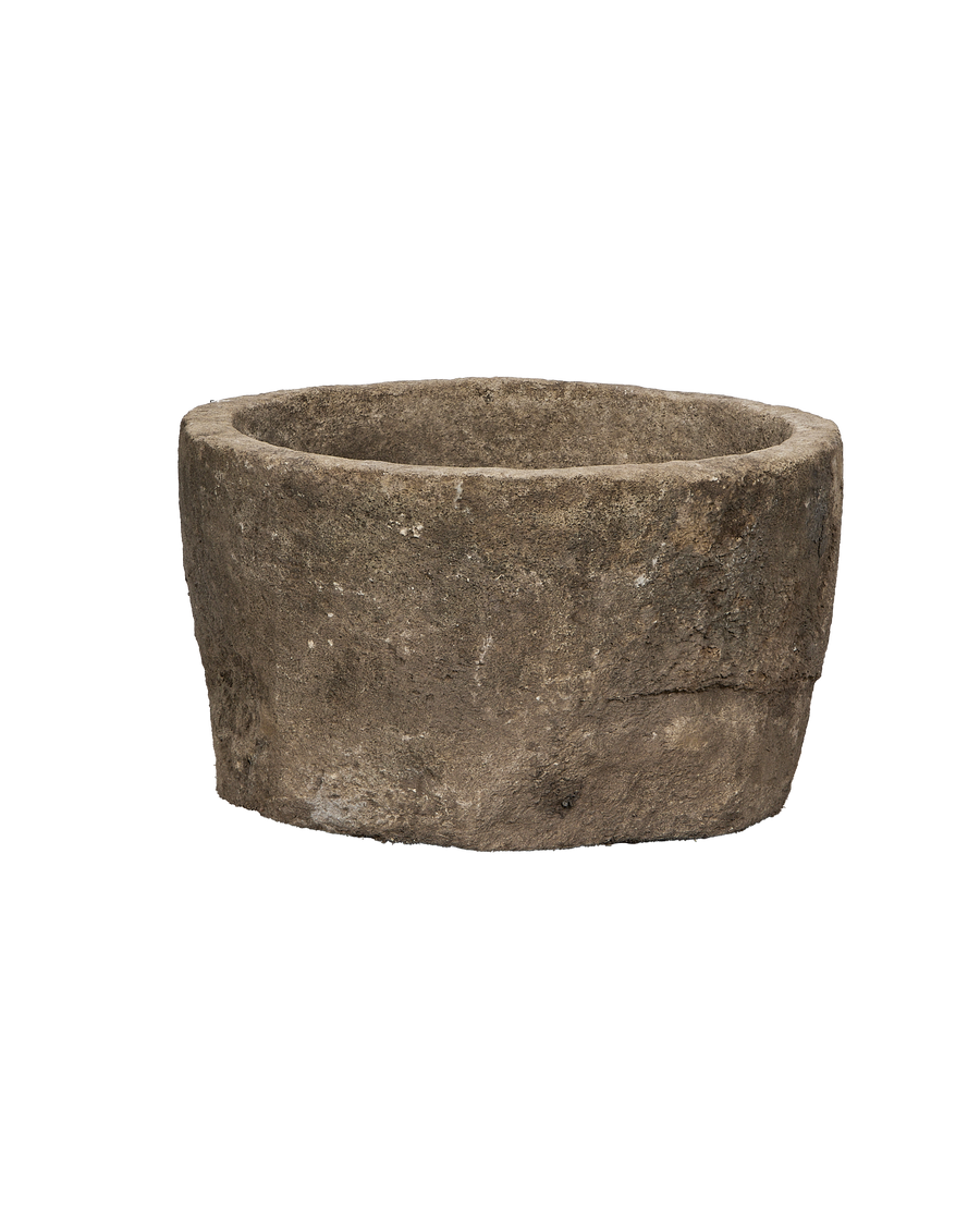Vintage round Indonesian limestone trough, showing a shallow interior and rugged exterior texture.