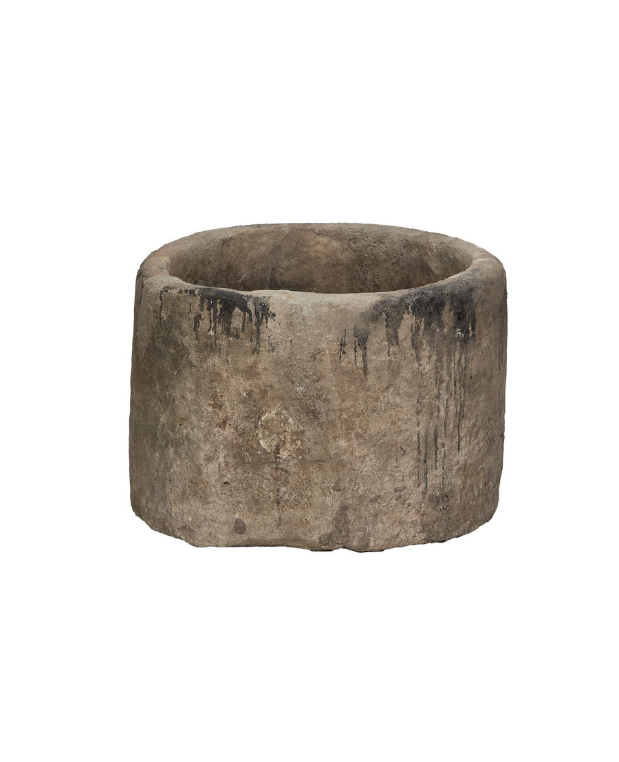 Vintage round limestone trough, side view revealing distressed surface and organic dark patina.
