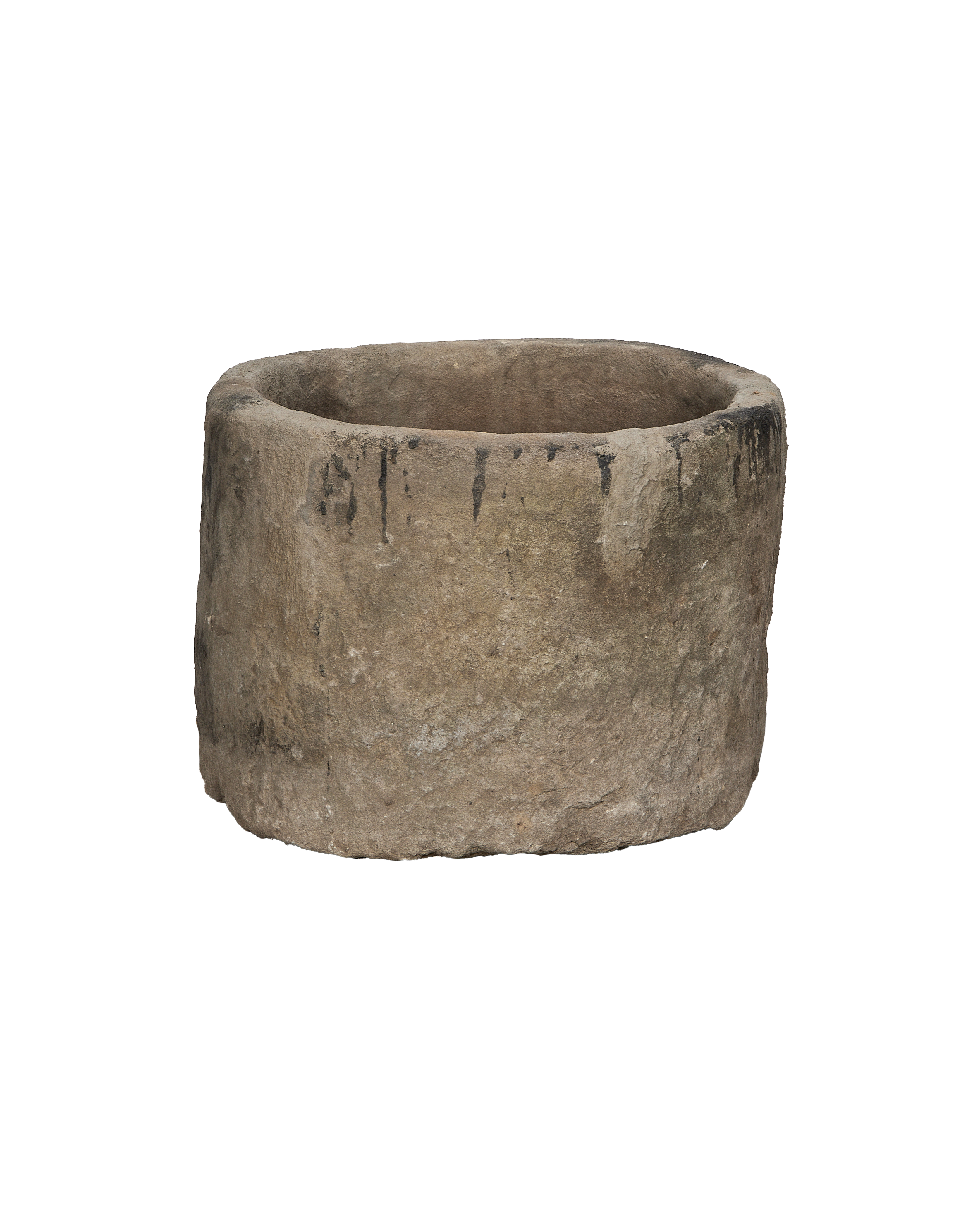 Vintage Indonesian round limestone trough, showing weathered texture and dark stains on rim.