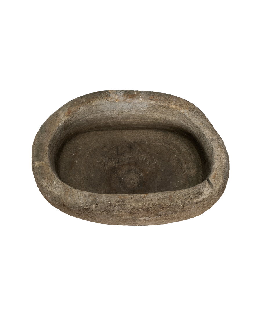 Vintage oblong limestone trough from Indonesia, interior showing texture and aged patina.
