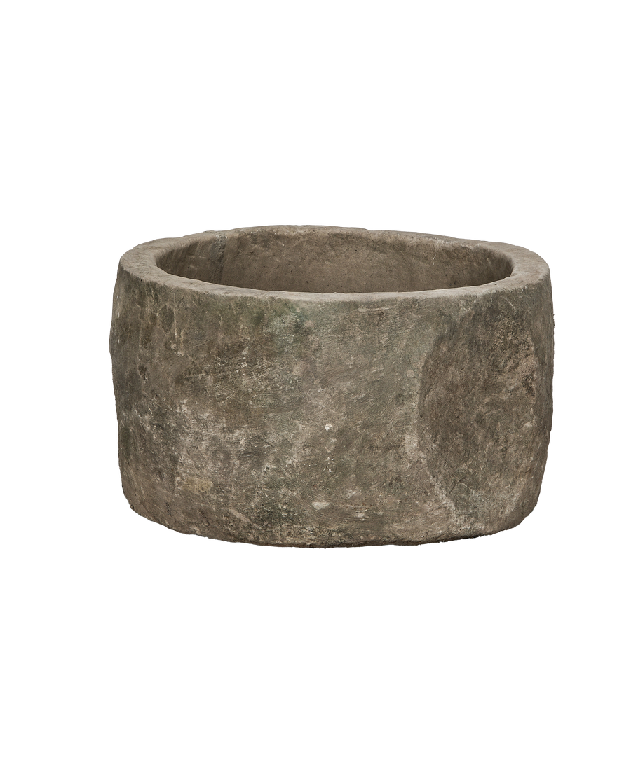Vintage Indonesian round limestone trough, side angle with detailed aged texture and patina.