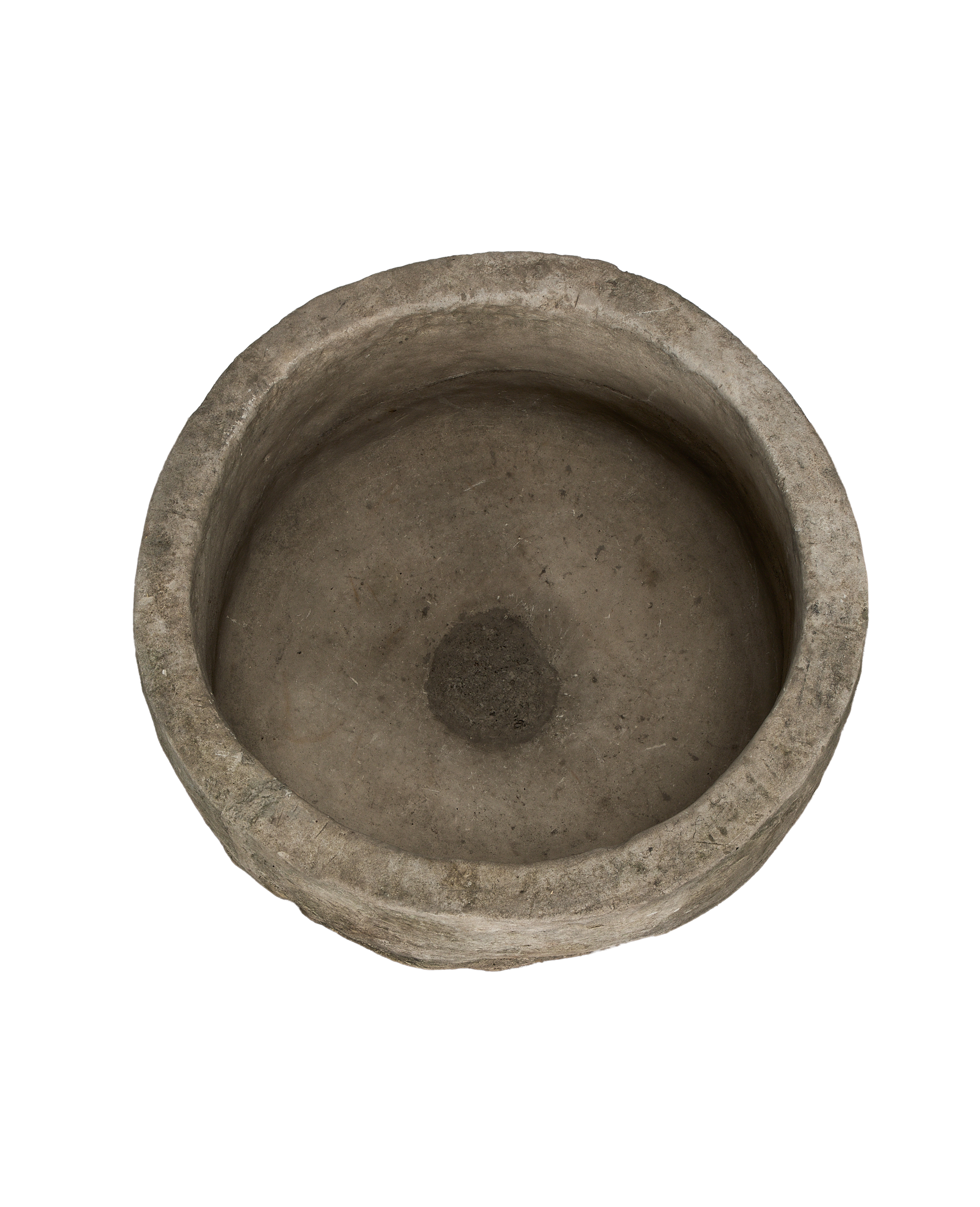 Round vintage Indonesian limestone trough, top view revealing rough interior texture and drain hole.