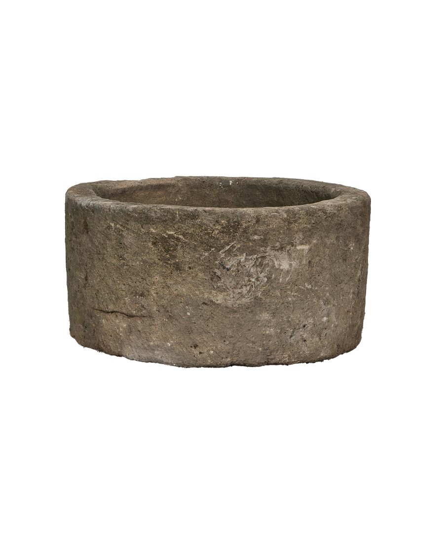 Vintage Indonesian round limestone trough, showing weathered texture and interior rim.