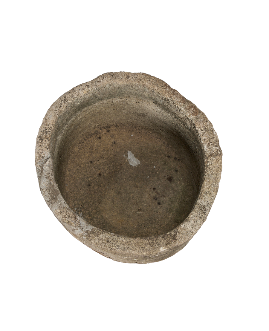 Vintage round Indonesian limestone trough, top view revealing aged texture and internal discoloration.