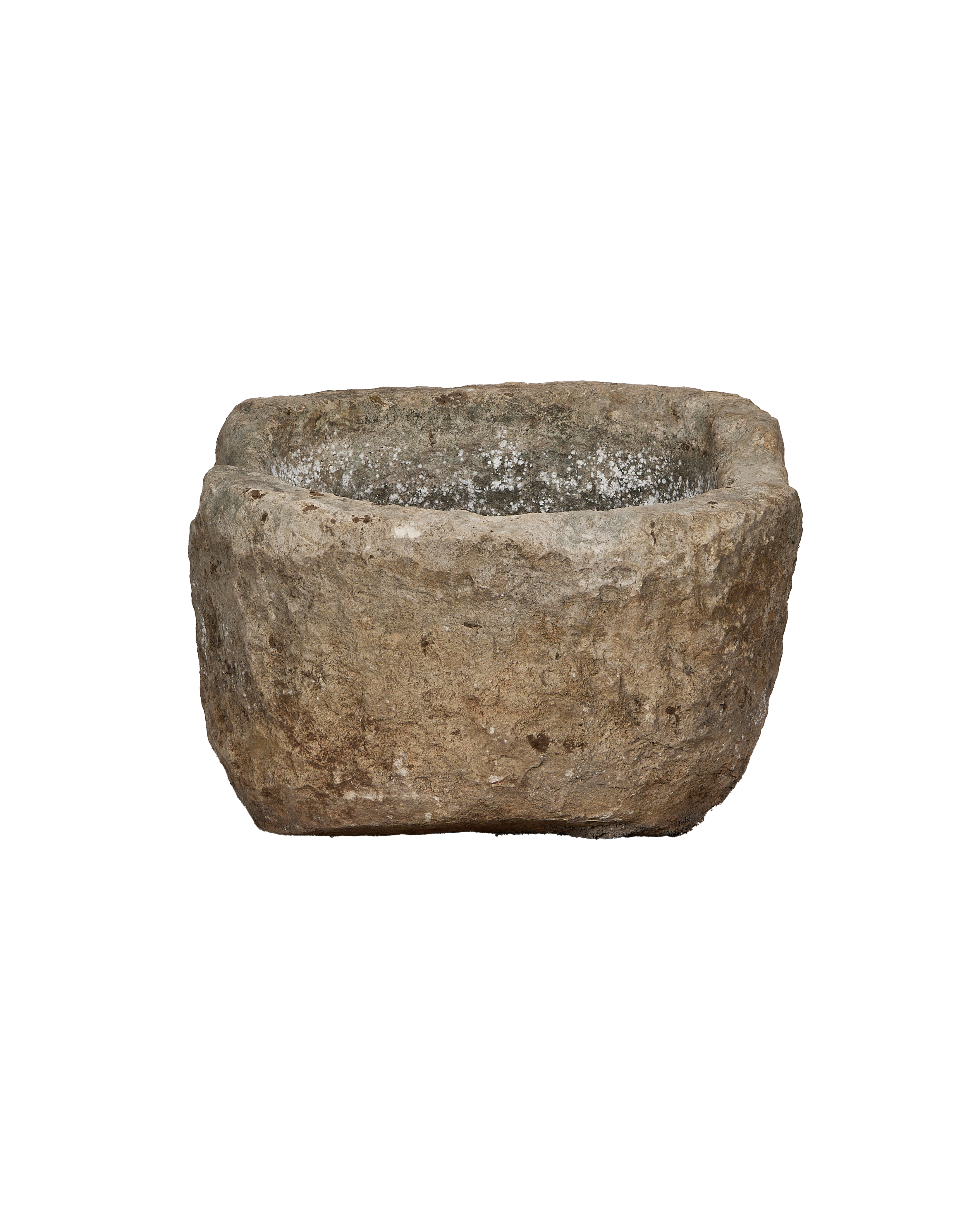 Vintage Indonesian limestone trough, showing rough exterior with white mineral deposits inside.