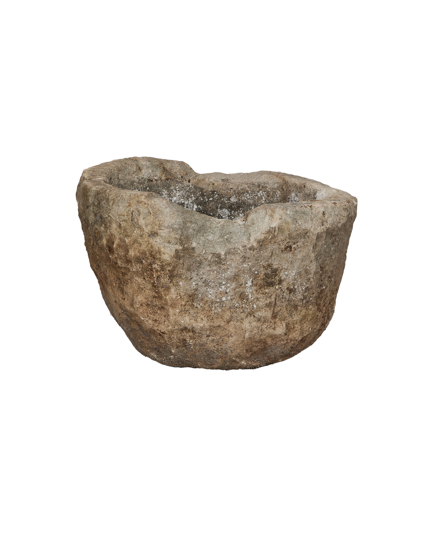 Vintage Indonesian round limestone trough, close-up of rough textured surface and weathered rim.