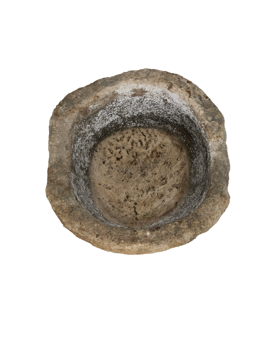 Vintage Indonesian round limestone trough, top-down view highlighting rough interior texture.