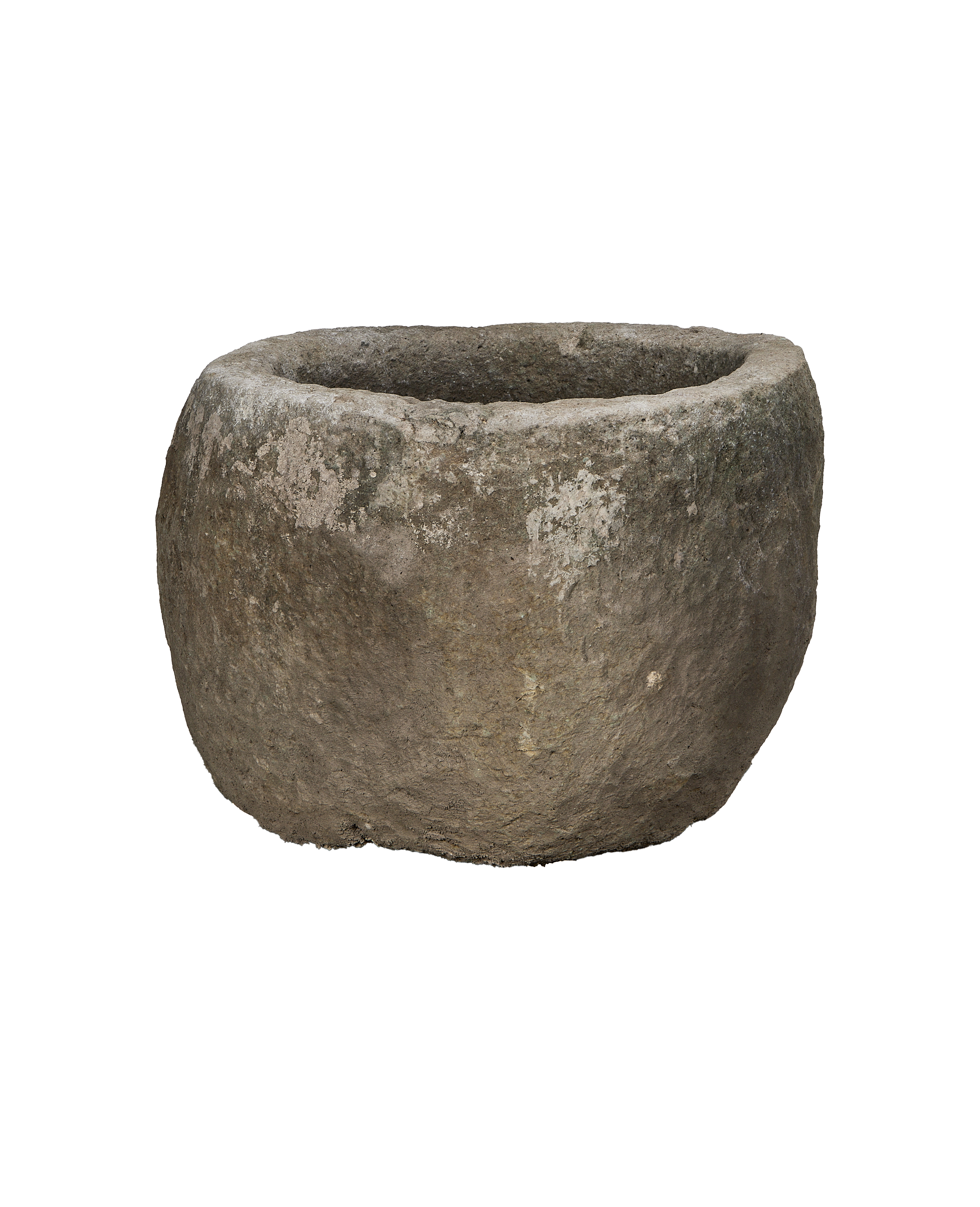 Vintage Indonesian limestone trough, showing rough textured exterior and circular opening imperfections.