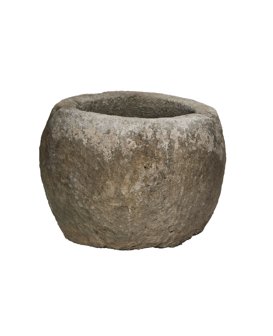 Vintage Indonesian round limestone trough, showing weathered texture from an elevated perspective.