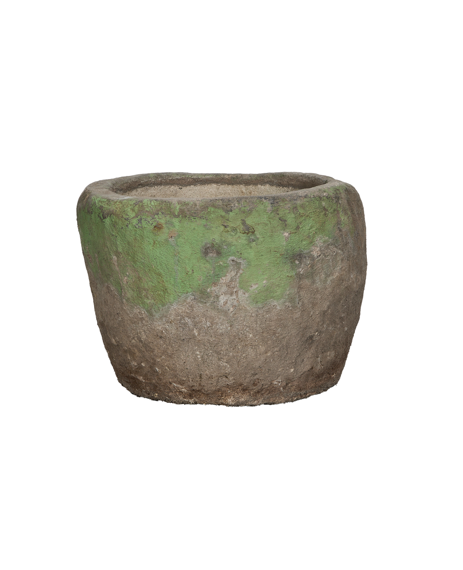Vintage Indonesian round limestone trough, green patina over weathered stone, side view.