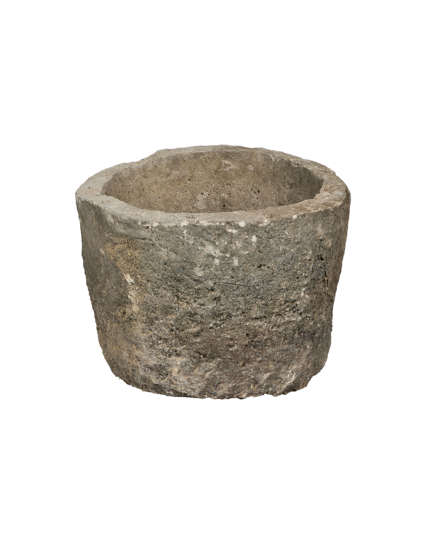 Vintage round limestone trough, OAK from Indonesia. Textured stone exterior in profile, showing rugged edge.
