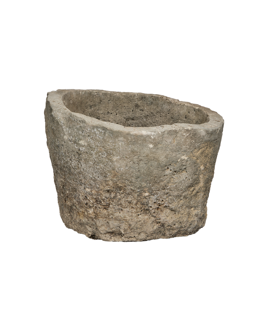 Vintage Indonesian round limestone trough, elevated view showing weathered texture and interior.