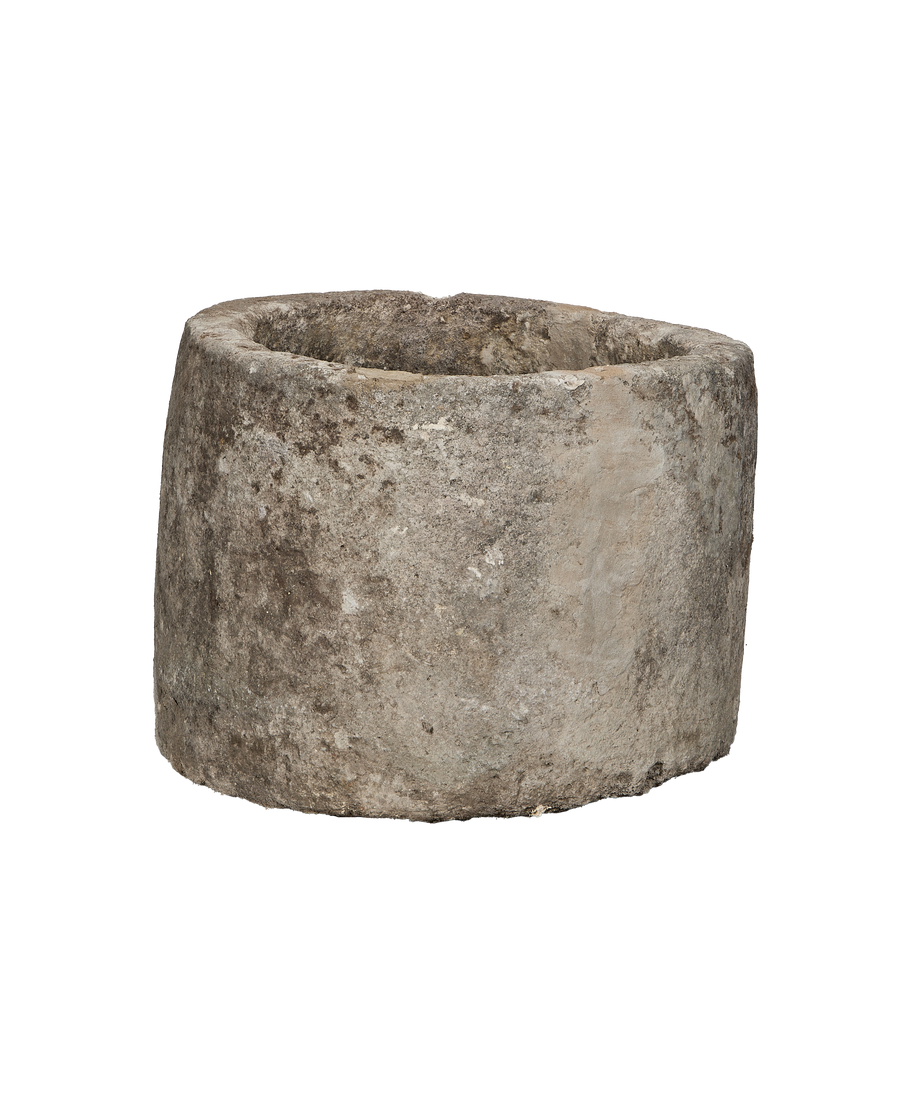 Vintage Indonesian round limestone trough, showing distressed texture and natural patina detail.