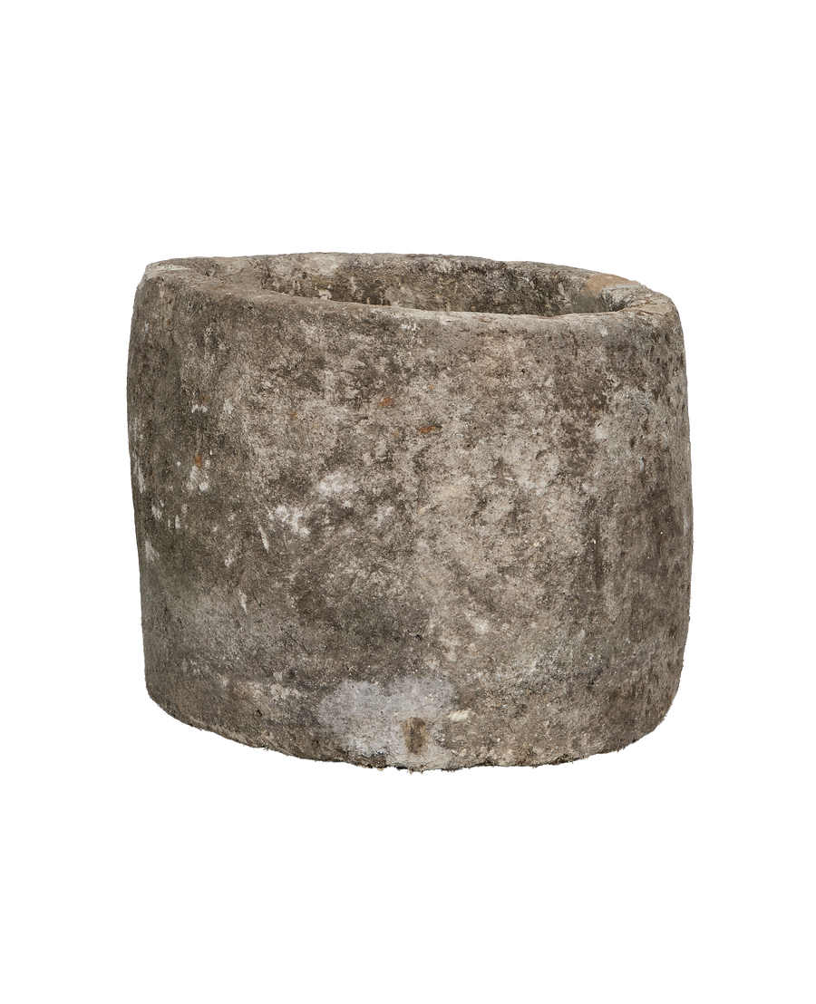 Vintage round limestone trough, coarse weathered texture, visible rim detail from a side angle.