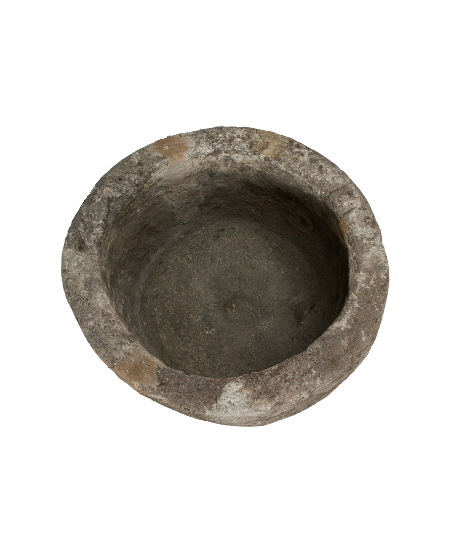 Vintage round Indonesian limestone trough, showing weathered interior surface and rustic rim.