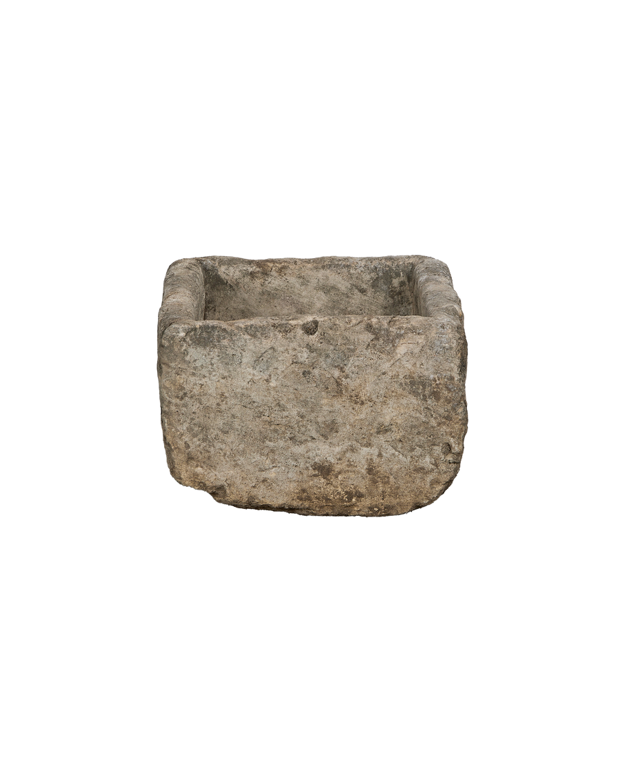 Vintage Indonesian rectangular limestone trough showing weathered, textured side with rough-hewn edges.