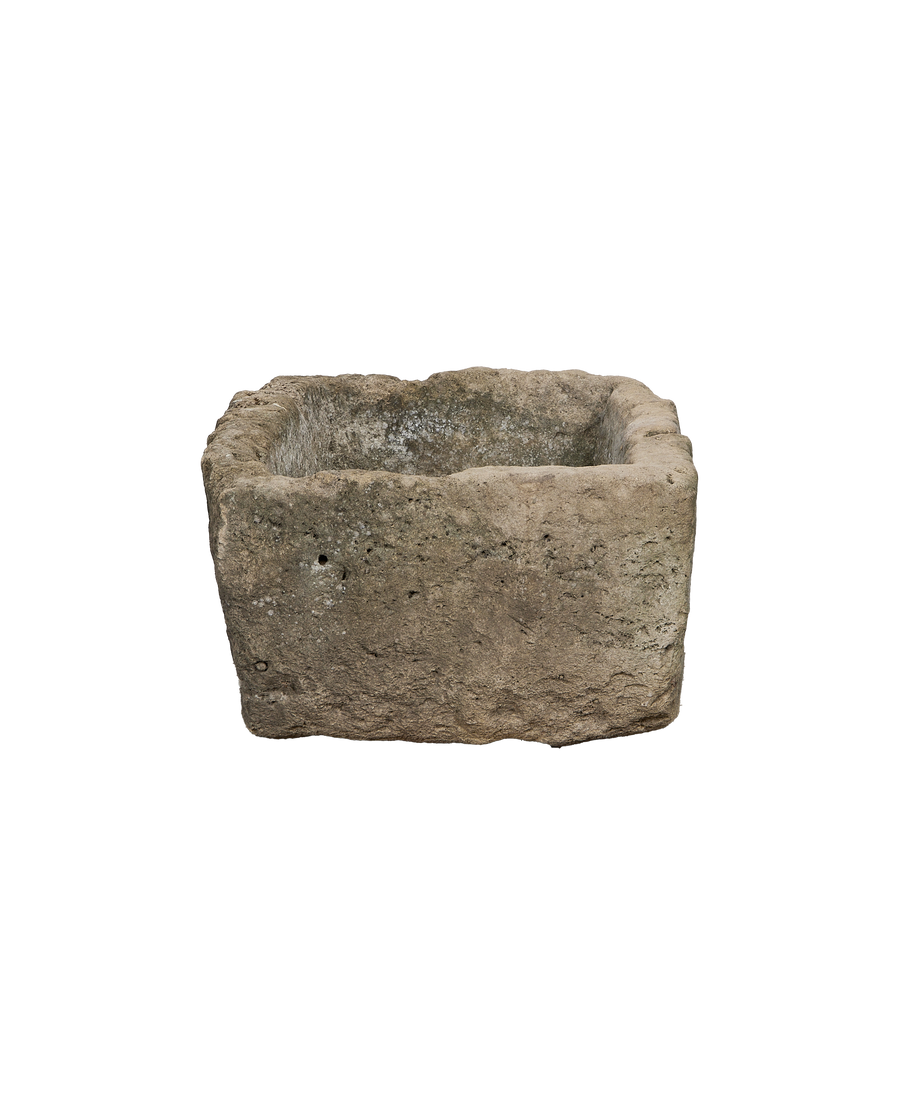 Rectangular vintage Indonesian limestone trough with rough, aged texture and visible interior.