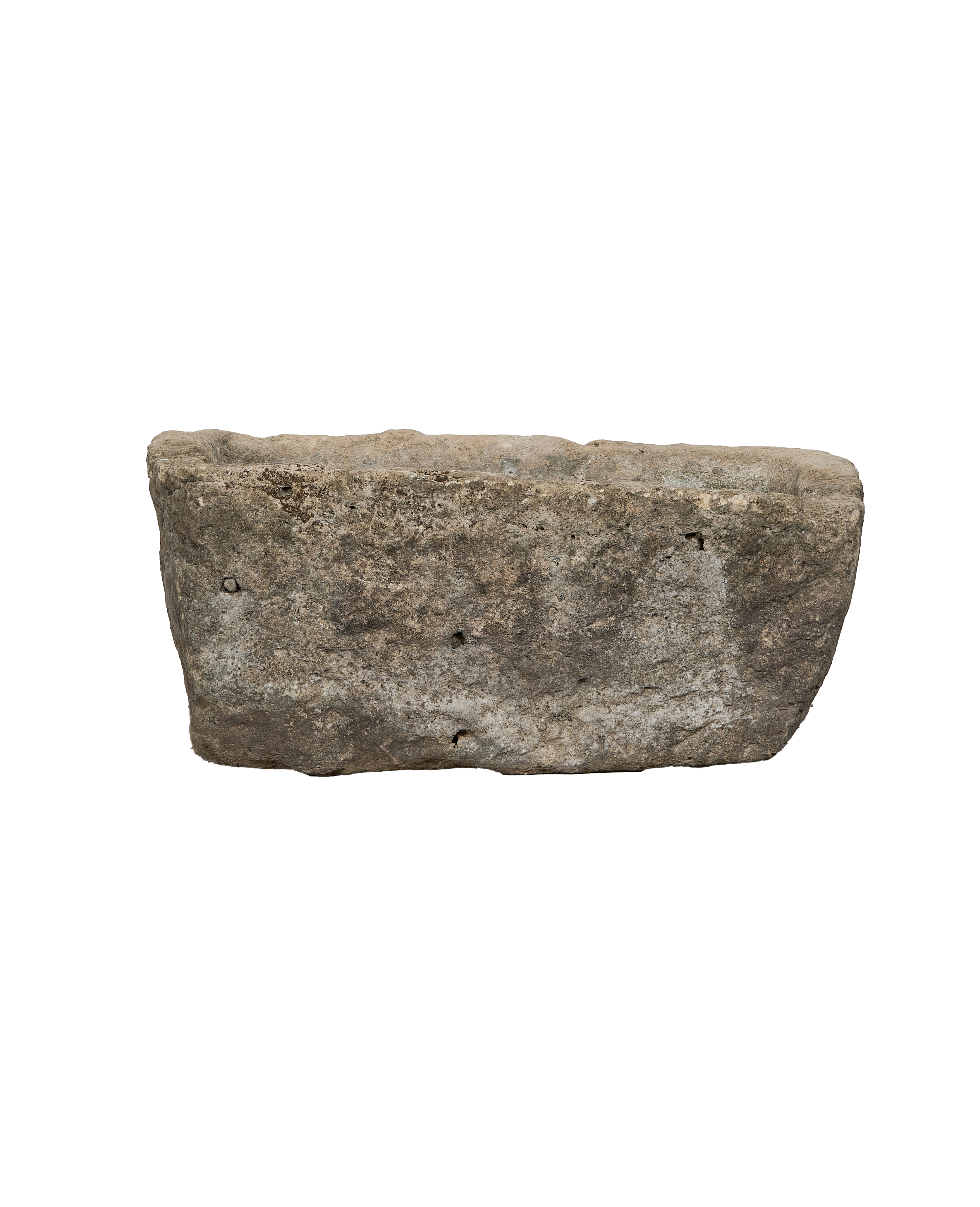 Rough-hewn vintage Indonesian limestone trough, showing weathered texture and natural imperfections, side angle.