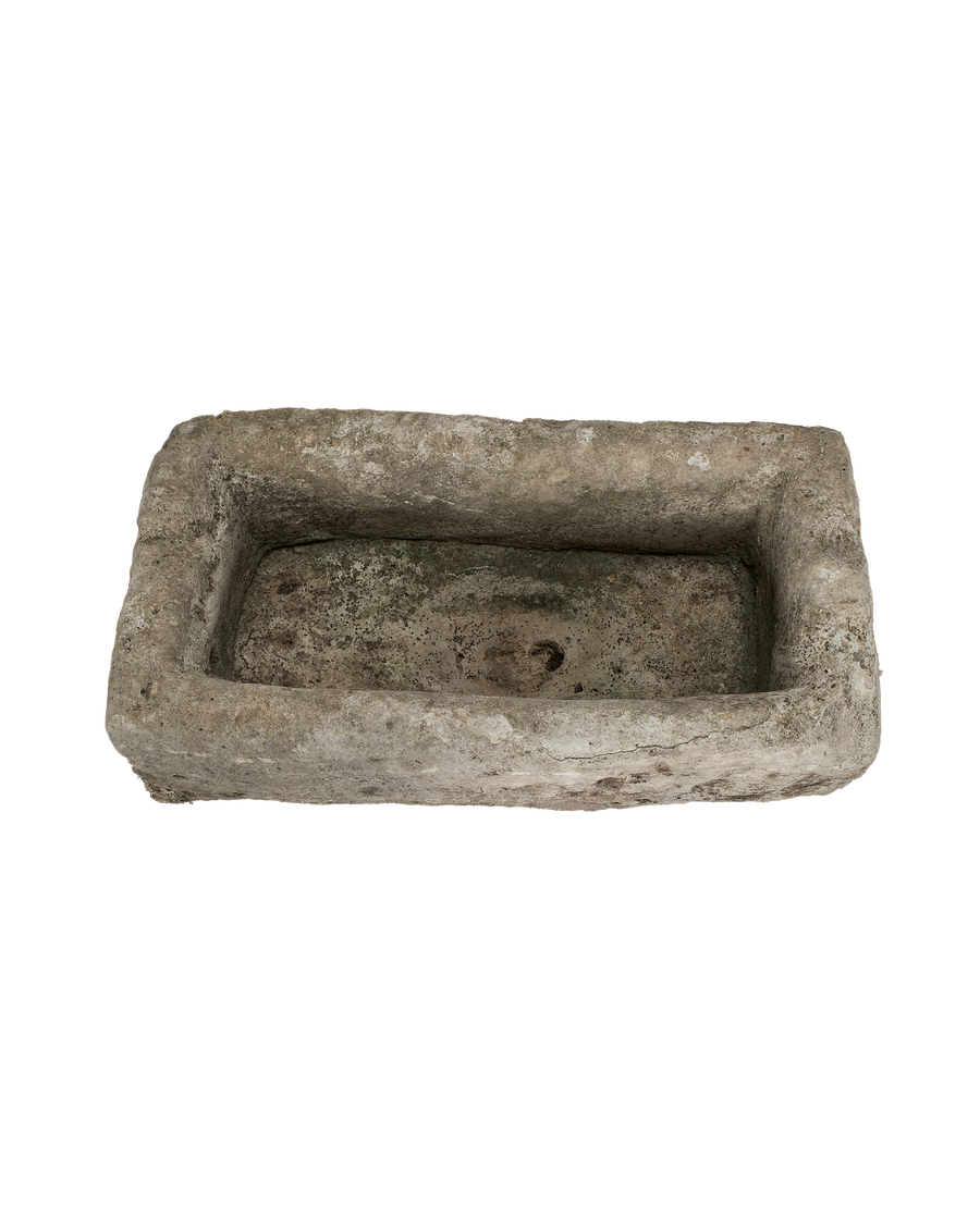 Vintage rectangular limestone trough, top view highlights weathered texture and aged patination.