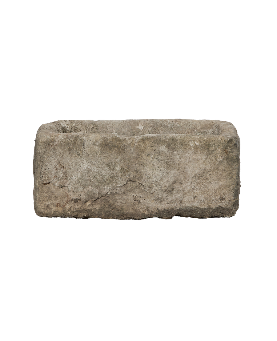 Vintage rectangular limestone trough, bottom view revealing natural weathered cracks in stone.