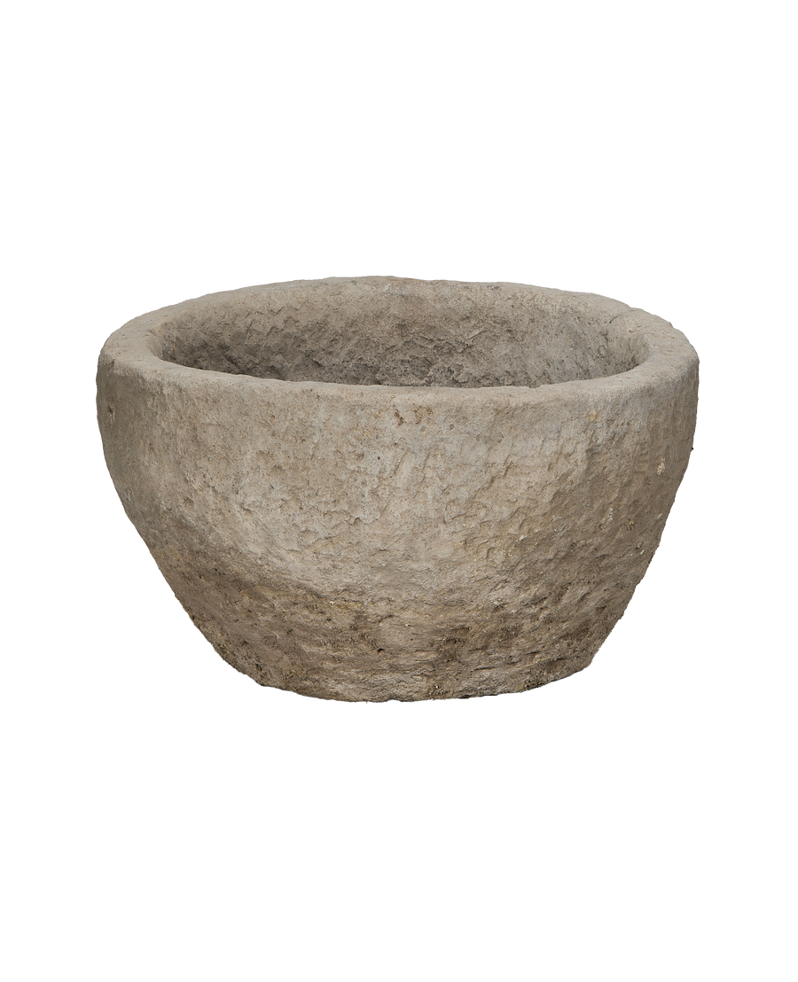 Vintage Indonesian round limestone planter trough, showing rough textured exterior.