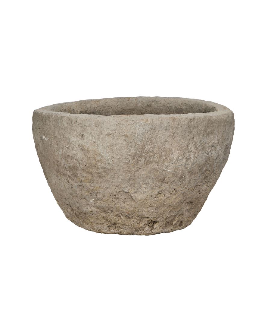 Vintage Indonesian round limestone trough, showing a side view of its rustic texture.