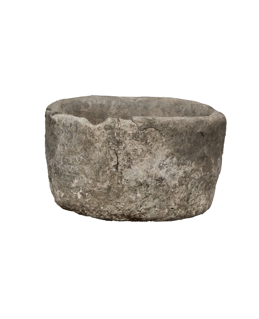 Vintage Indonesian limestone trough, round, showing detailed weathered texture and age-related chips.