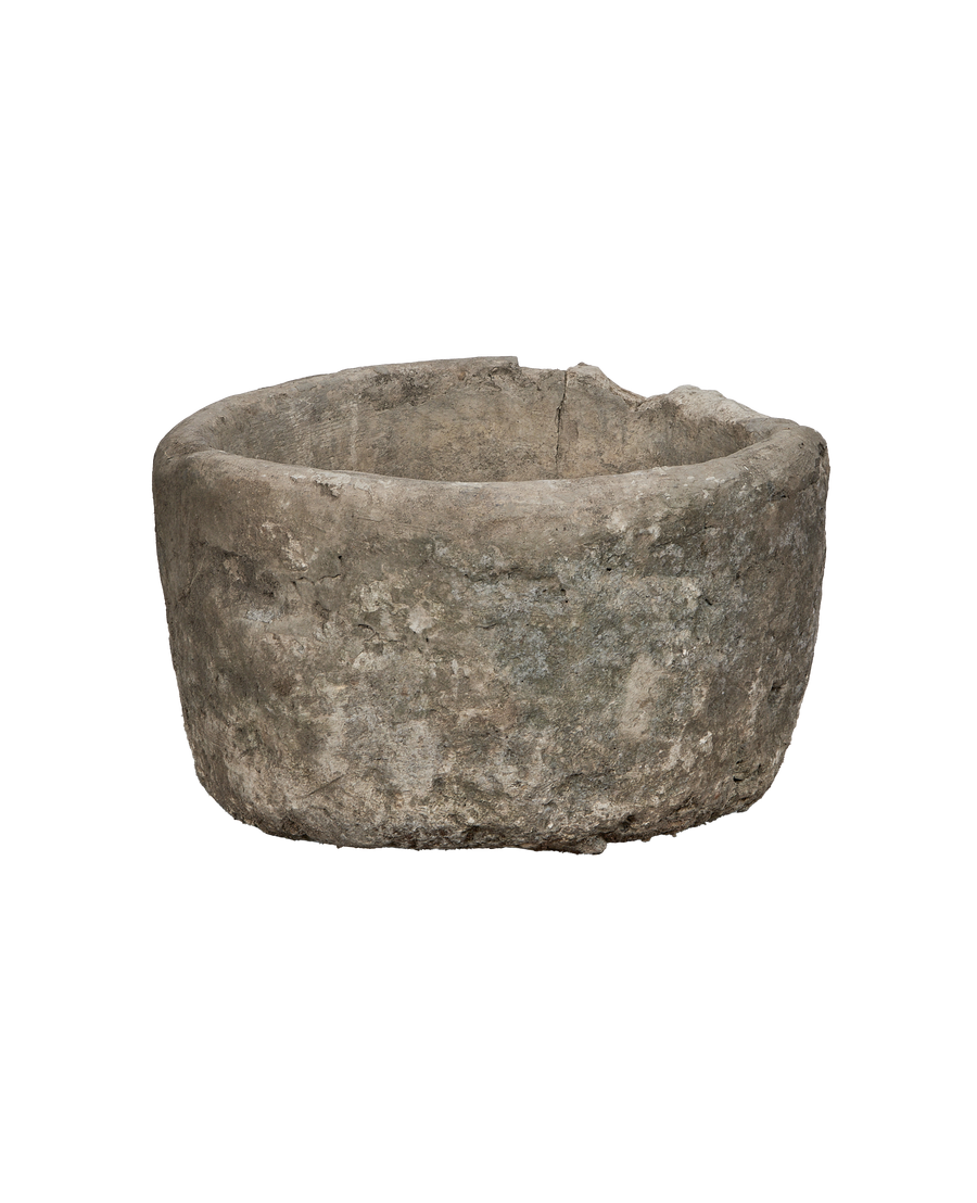 Vintage Indonesian limestone trough closeup, showcasing rough texture and weathered finish.