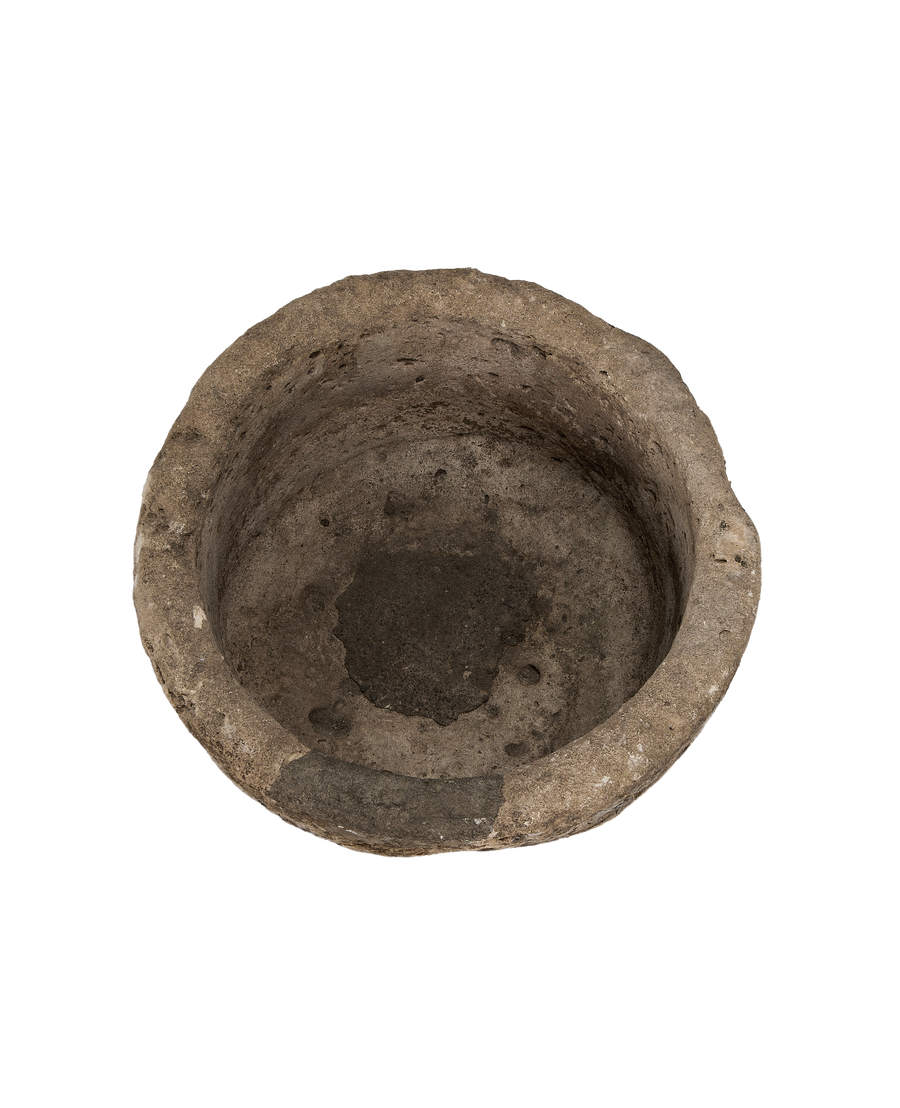 Vintage Indonesian round limestone trough, showing weathered interior surface texture from above.