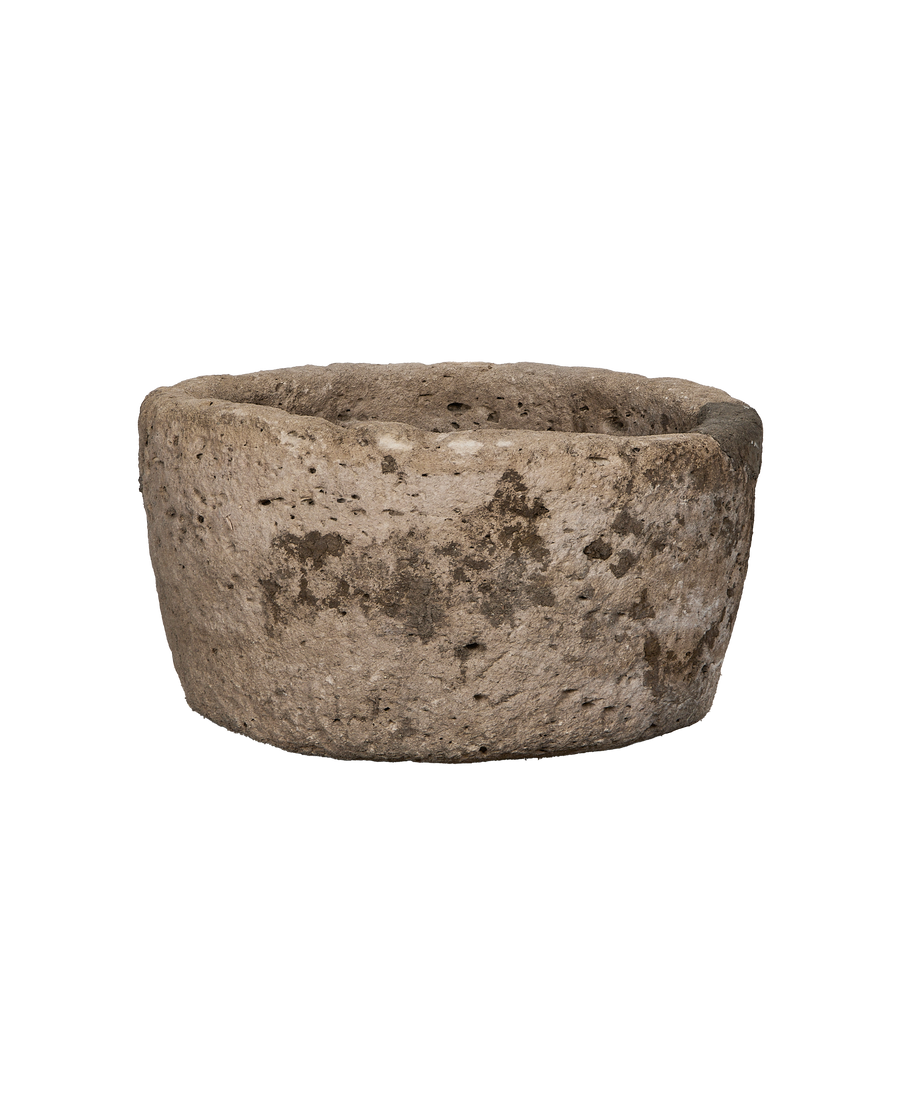 Vintage round limestone trough from Indonesia, showing rough texture, pitting, and weathered surface.