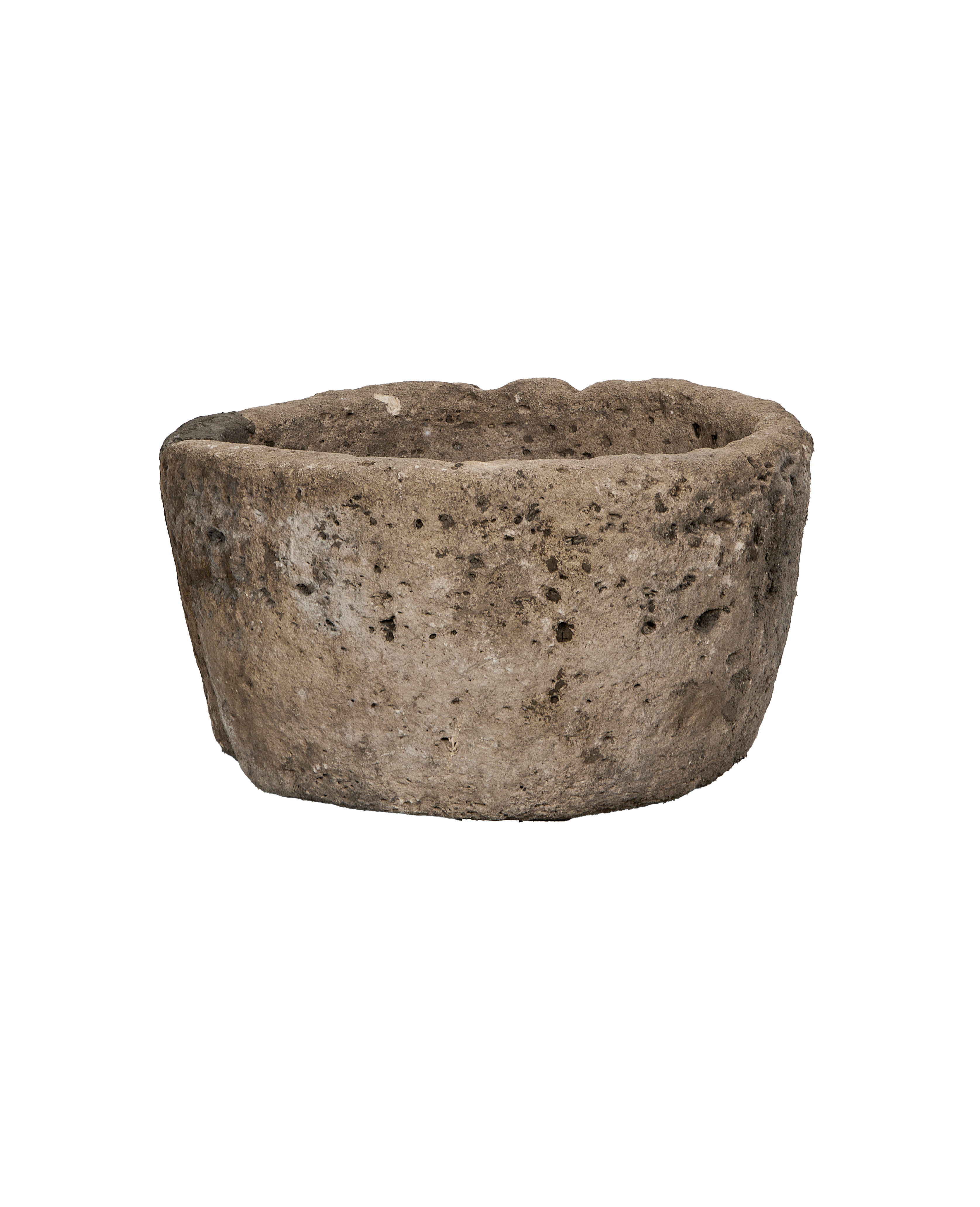 Vintage Indonesian round limestone trough, close-up of textured surface and rough rim.